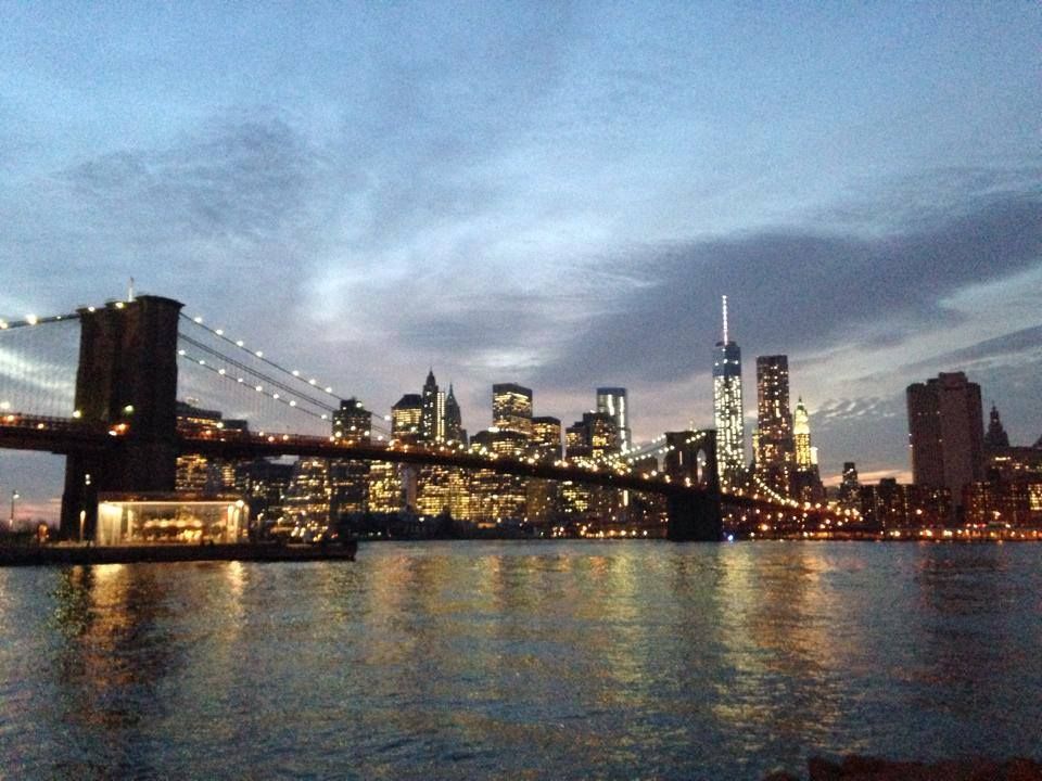 Night falls on Brooklyn Bridge and the Financial District skyline