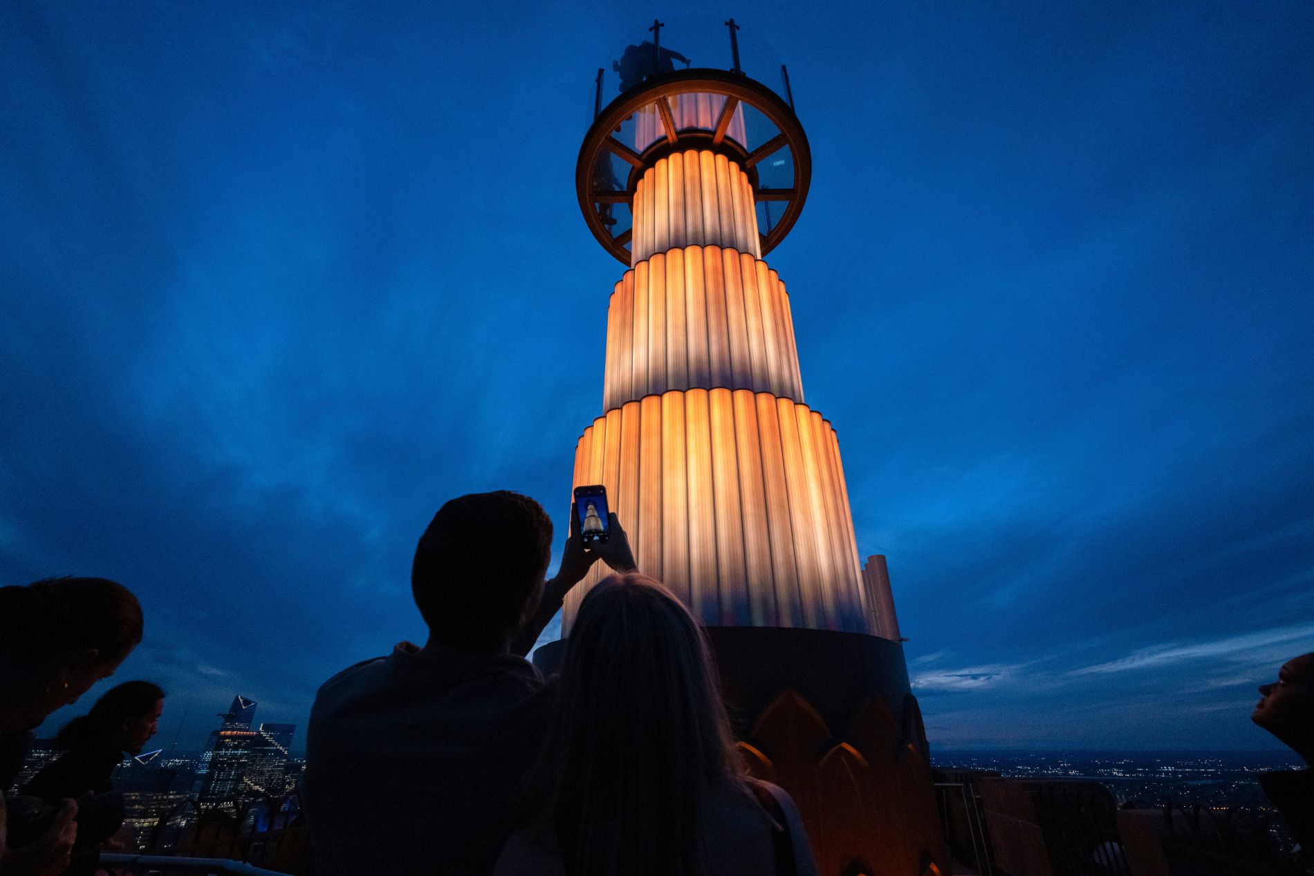 Couple photographing the SkyLift attraction at Top of the Rock in New York